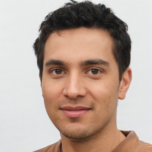 Joyful white young-adult male with short  black hair and brown eyes