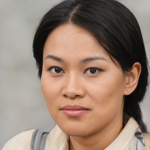 Joyful asian young-adult female with medium  brown hair and brown eyes
