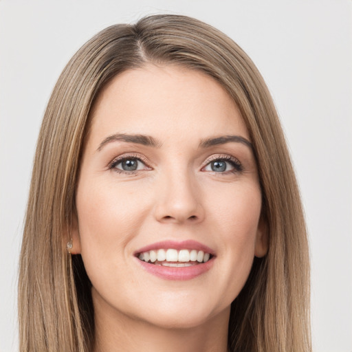 Joyful white young-adult female with long  brown hair and green eyes