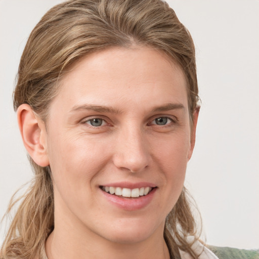 Joyful white young-adult female with medium  brown hair and blue eyes