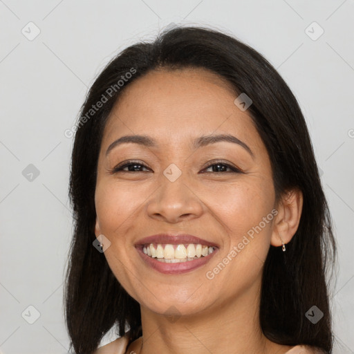 Joyful white adult female with long  brown hair and brown eyes