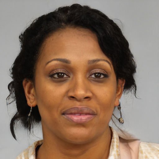 Joyful black adult female with medium  brown hair and brown eyes