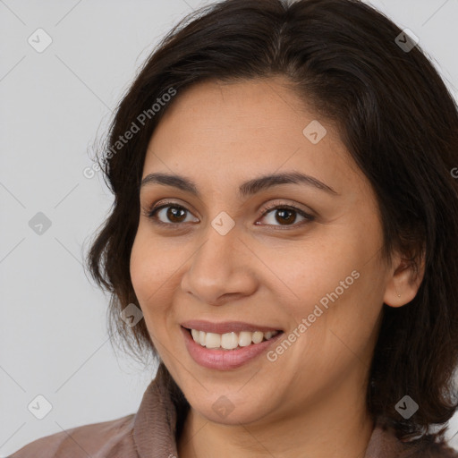 Joyful white young-adult female with medium  brown hair and brown eyes