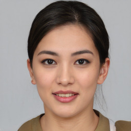 Joyful asian young-adult female with medium  brown hair and brown eyes