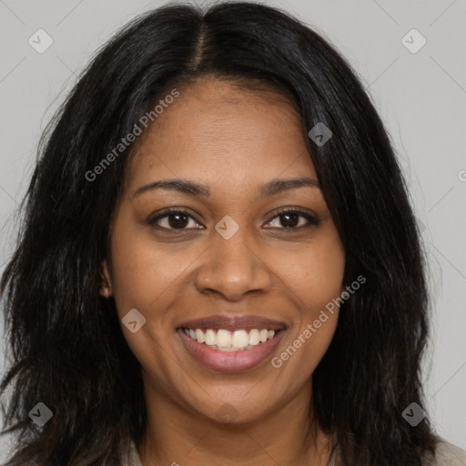 Joyful black young-adult female with long  brown hair and brown eyes