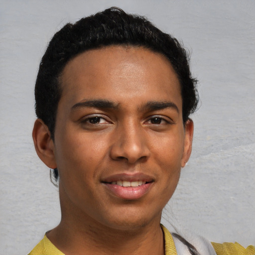 Joyful black young-adult male with short  brown hair and brown eyes