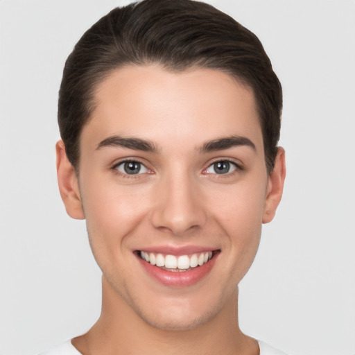 Joyful white young-adult female with short  brown hair and brown eyes