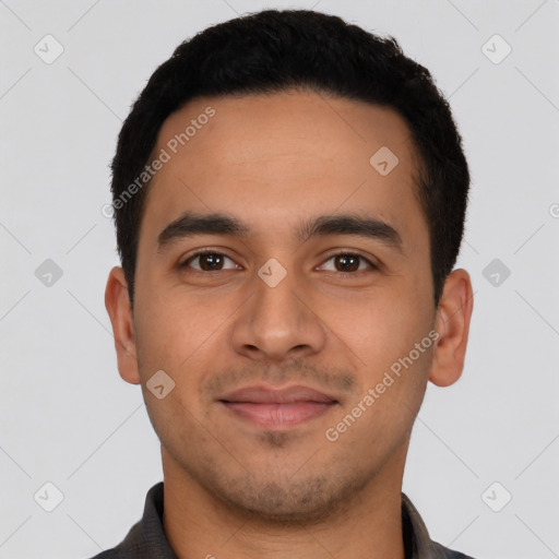 Joyful latino young-adult male with short  black hair and brown eyes