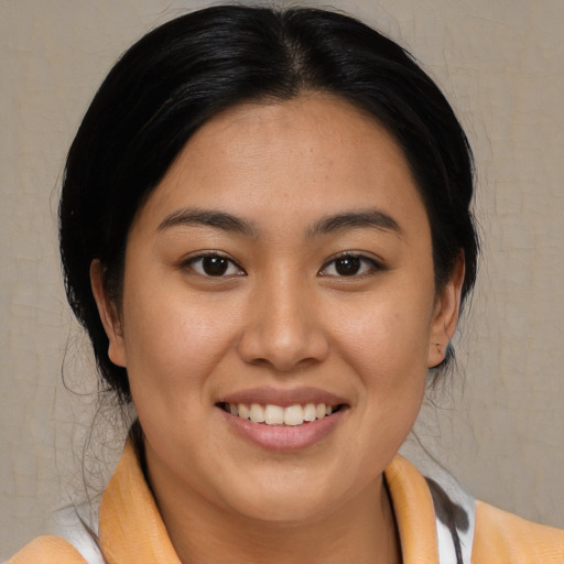 Joyful asian young-adult female with medium  black hair and brown eyes