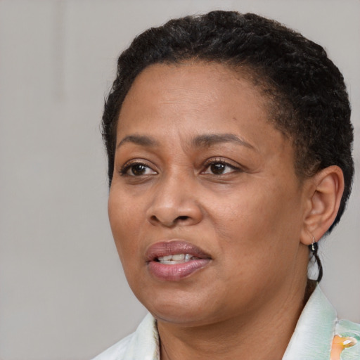 Joyful black adult female with short  brown hair and brown eyes
