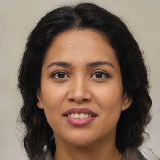 Joyful latino young-adult female with medium  brown hair and brown eyes