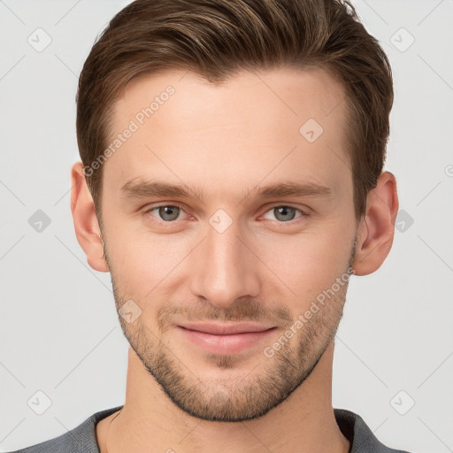 Joyful white young-adult male with short  brown hair and grey eyes