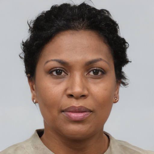 Joyful black adult female with short  brown hair and brown eyes