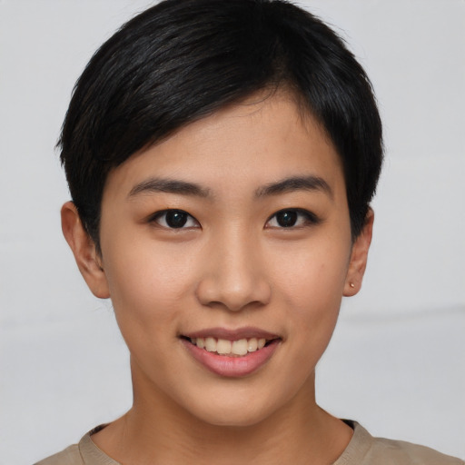 Joyful asian young-adult female with short  brown hair and brown eyes