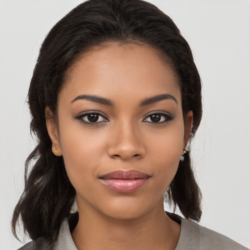 Joyful latino young-adult female with medium  brown hair and brown eyes