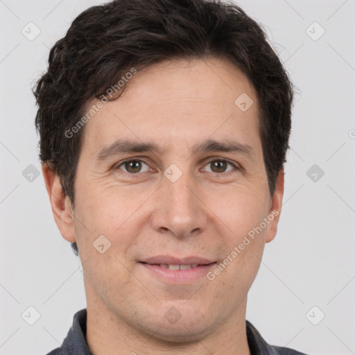 Joyful white adult male with short  brown hair and brown eyes