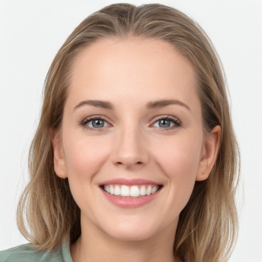 Joyful white young-adult female with long  brown hair and blue eyes