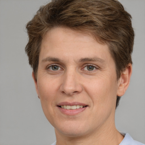 Joyful white adult male with short  brown hair and green eyes