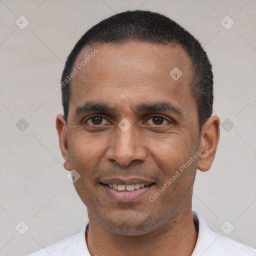 Joyful latino adult male with short  black hair and brown eyes