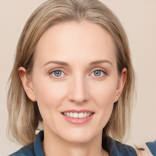 Joyful white young-adult female with medium  brown hair and blue eyes