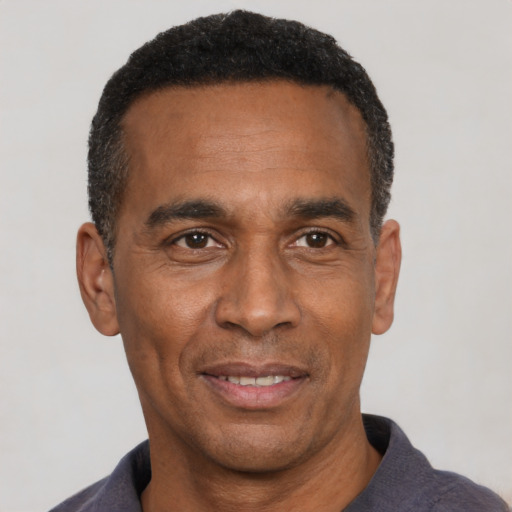 Joyful latino adult male with short  black hair and brown eyes