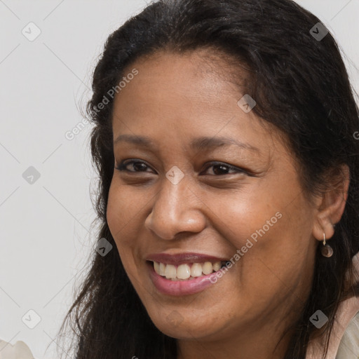 Joyful white adult female with long  brown hair and brown eyes