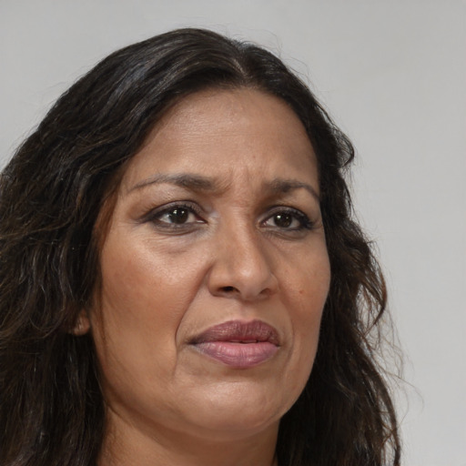 Joyful white adult female with long  brown hair and brown eyes