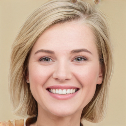 Joyful white young-adult female with medium  brown hair and blue eyes