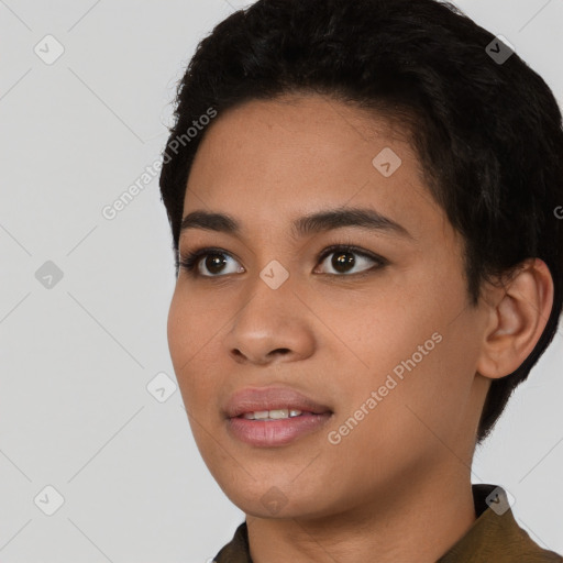 Joyful black young-adult female with short  black hair and brown eyes