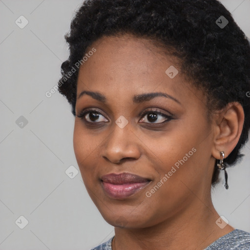 Joyful black young-adult female with short  black hair and brown eyes