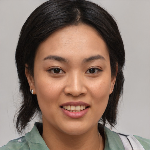 Joyful asian young-adult female with medium  brown hair and brown eyes