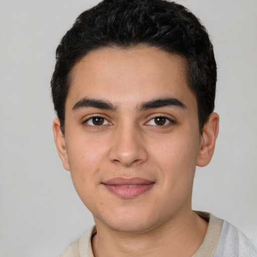 Joyful white young-adult male with short  black hair and brown eyes