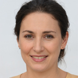 Joyful white adult female with medium  brown hair and brown eyes