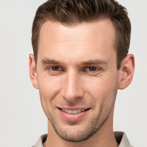 Joyful white young-adult male with short  brown hair and brown eyes