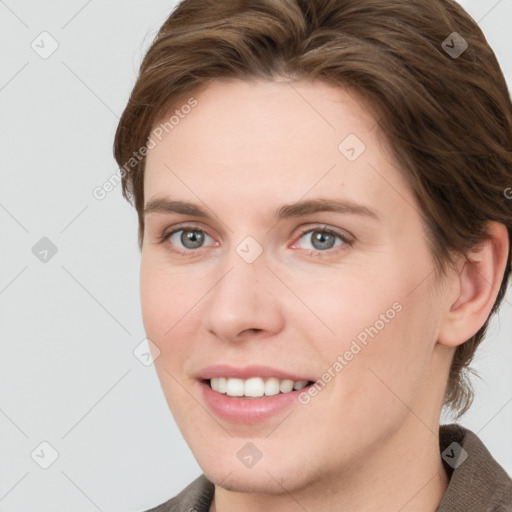 Joyful white young-adult female with short  brown hair and grey eyes