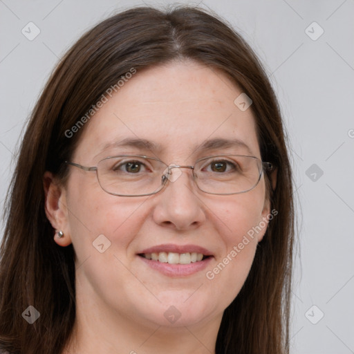 Joyful white adult female with long  brown hair and grey eyes