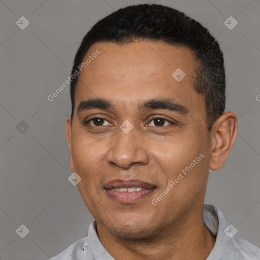 Joyful latino young-adult male with short  black hair and brown eyes