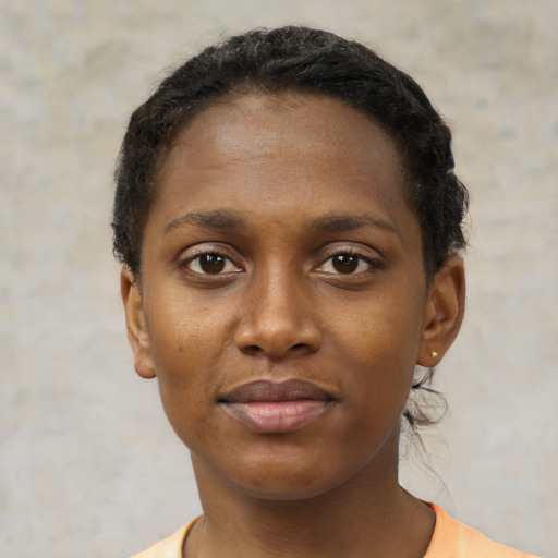 Joyful black young-adult female with short  brown hair and brown eyes