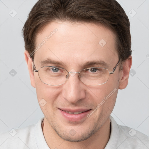 Joyful white adult male with short  brown hair and grey eyes