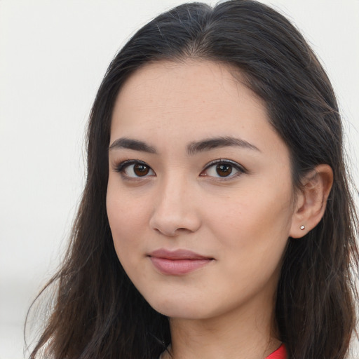 Joyful asian young-adult female with long  brown hair and brown eyes