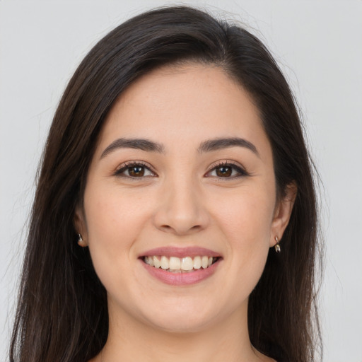 Joyful white young-adult female with long  brown hair and brown eyes