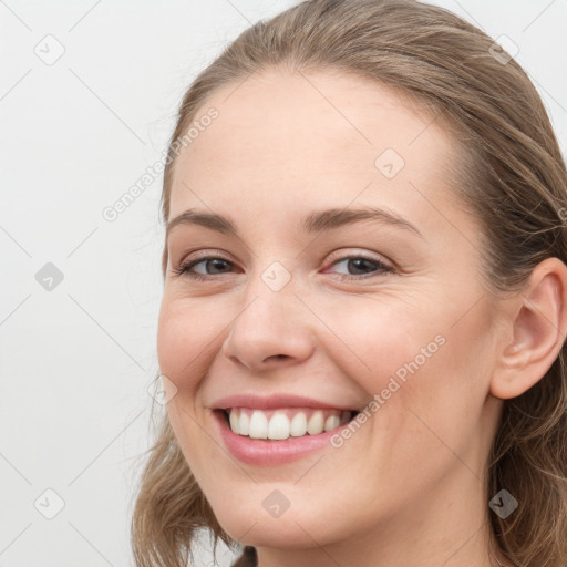 Joyful white young-adult female with long  brown hair and grey eyes