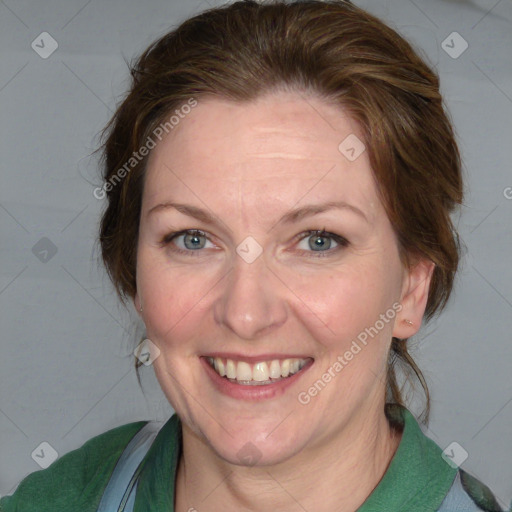 Joyful white adult female with medium  brown hair and blue eyes