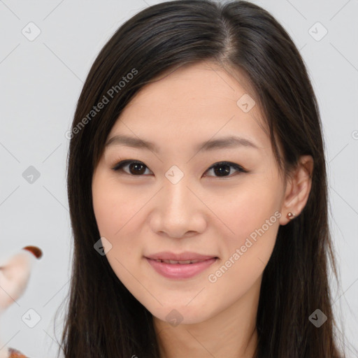 Joyful asian young-adult female with long  brown hair and brown eyes