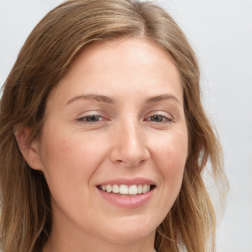 Joyful white young-adult female with long  brown hair and grey eyes