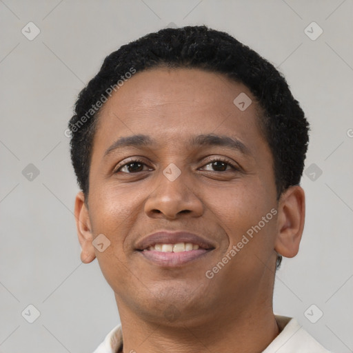 Joyful black young-adult male with short  brown hair and brown eyes