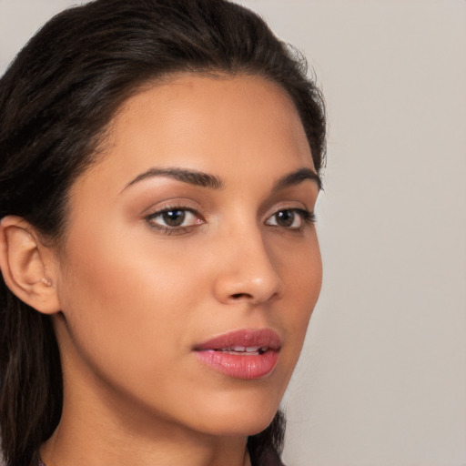 Joyful latino young-adult female with long  brown hair and brown eyes