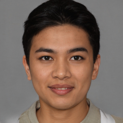 Joyful asian young-adult male with short  brown hair and brown eyes