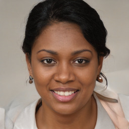 Joyful black young-adult female with medium  brown hair and brown eyes