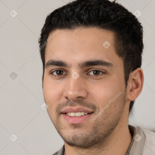 Joyful white young-adult male with short  black hair and brown eyes